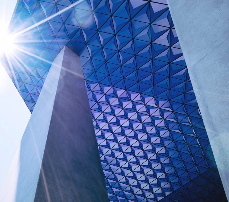 Modern university building against a blue sky